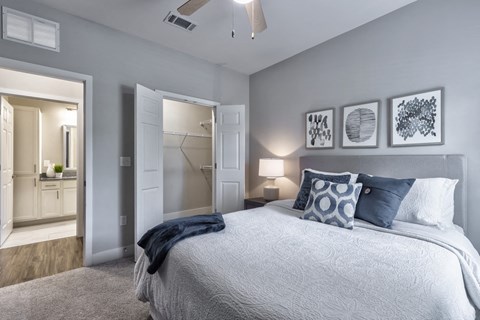 a bedroom with a large bed and a closet