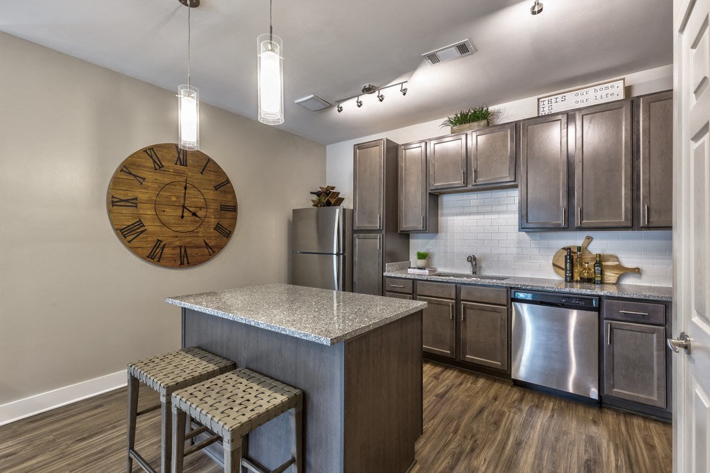a kitchen with stainless steel appliances and granite counter tops