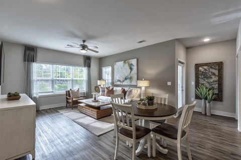 an open living room and dining room with a table and chairs