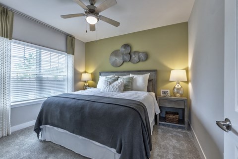 a bedroom with a bed and a ceiling fan