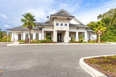 a large white house with palm trees in front of it