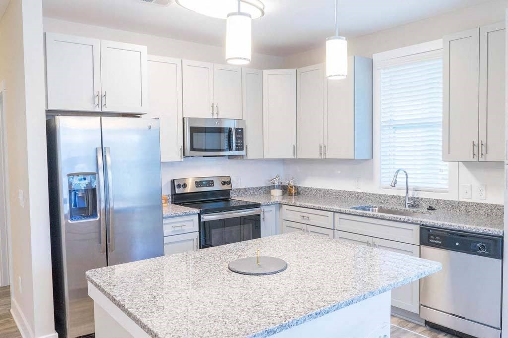 A kitchen with a granite countertop and stainless steel appliances. at Foxwood Apartments, North Carolina