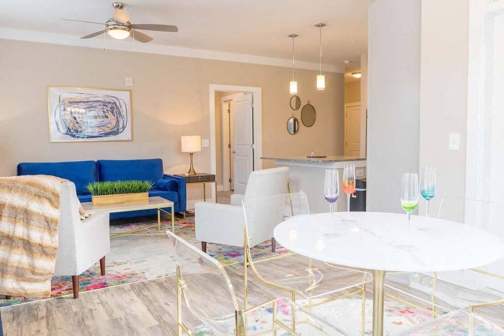 A living room with a blue couch and a white coffee table at Foxwood Apartments, Raleigh-Durham, North Carolina