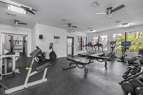A spacious gym with a variety of equipment including weights and cardio machines.