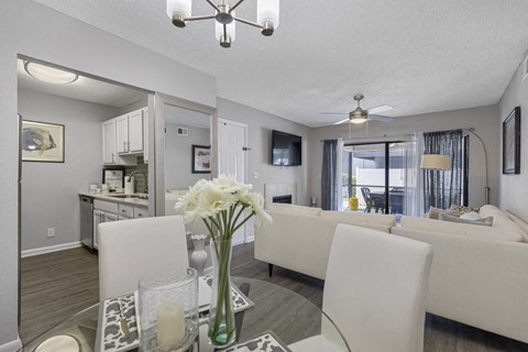 A living room with a dining table and chairs.