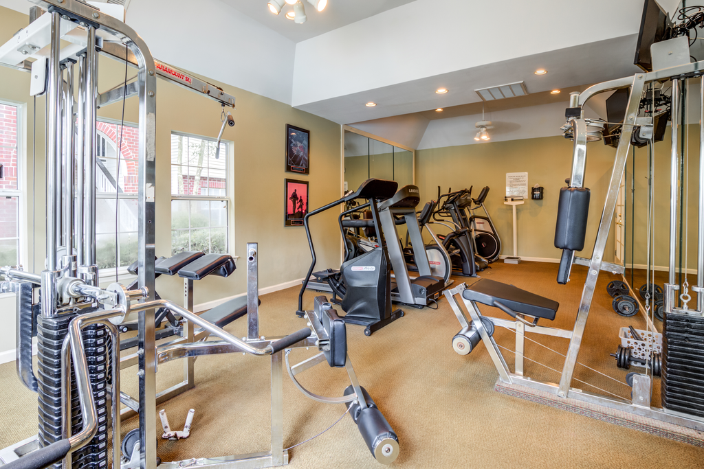 Fitness Center with exercise equipment, three windows and a mirror accent wall.