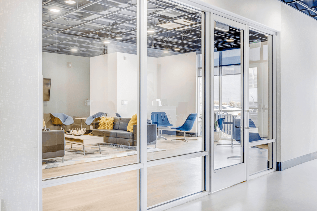 clubhouse room filled with furniture and a large window
