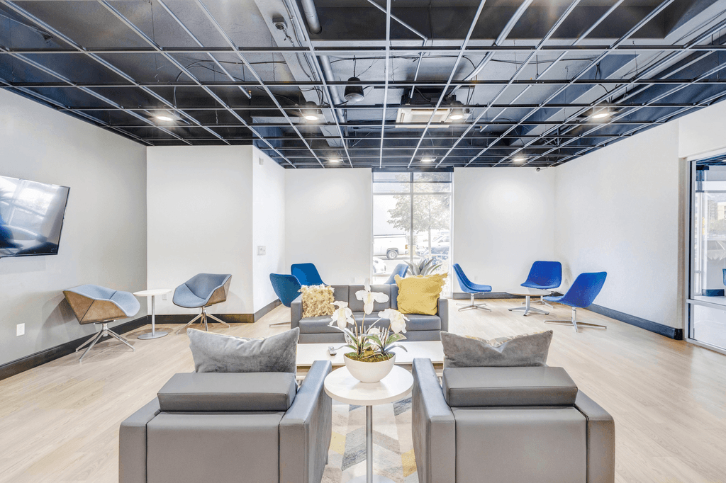 A modern living room with grey and blue furniture.