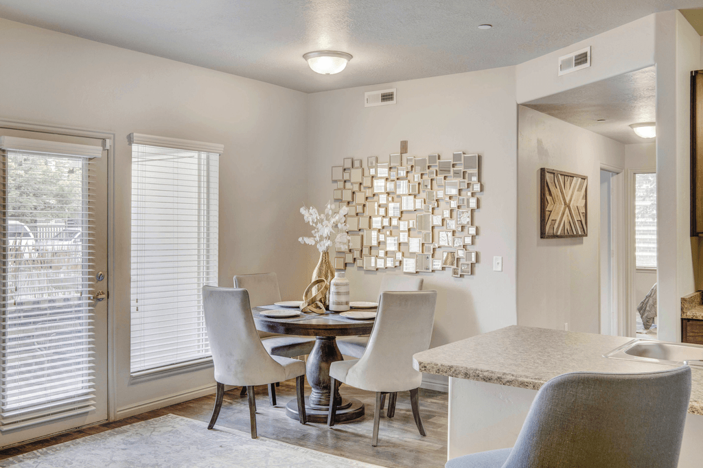 A modern dining room with a table set for four.