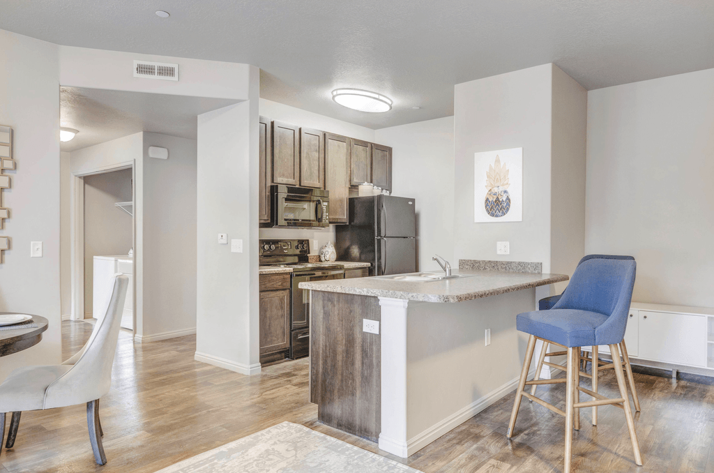 a kitchen and dining area with hardwood-style flooring