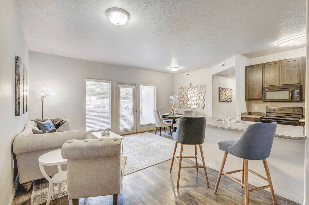 staged living room with hardwood-style flooring and windows