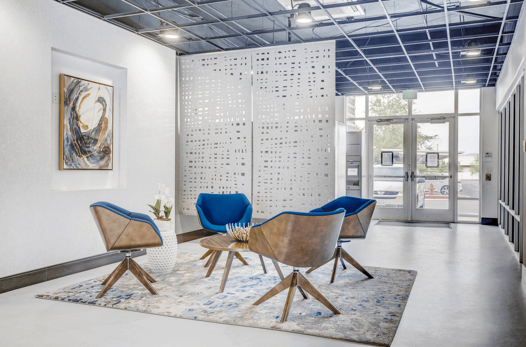 a seating area with two chairs and a coffee table