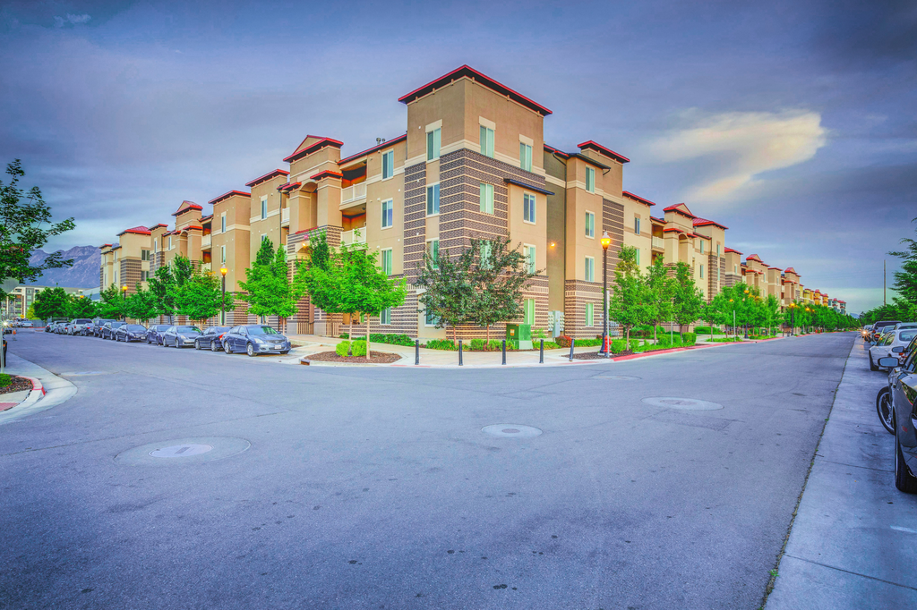 Building exterior with parallel parking and native landscaping.