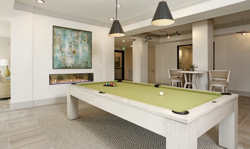 a game room with a pool table and a fire place
