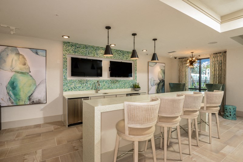 a bar with chairs and a television in a living room