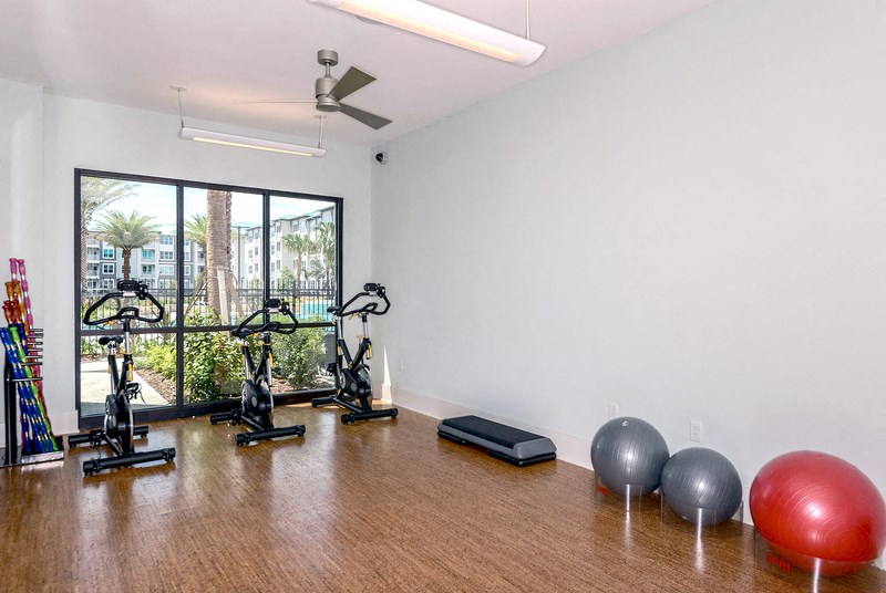 a workout room with exercise equipment and a large window