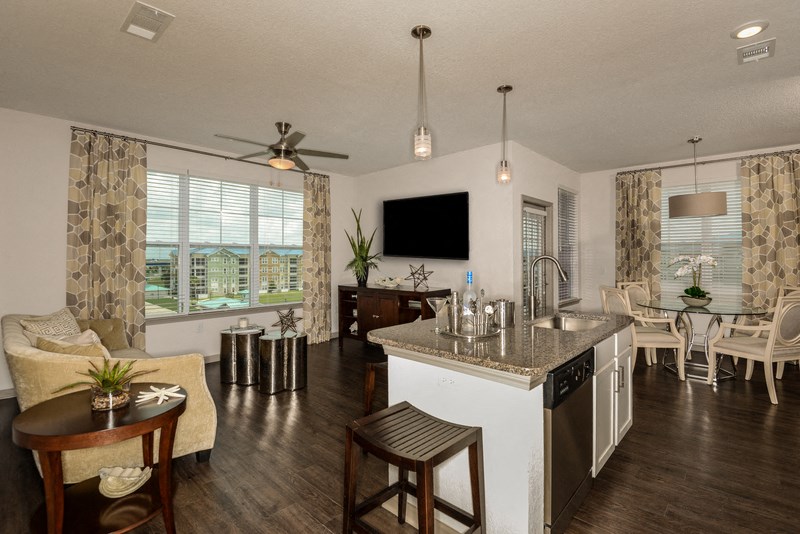 a living room with a kitchen and a dining room