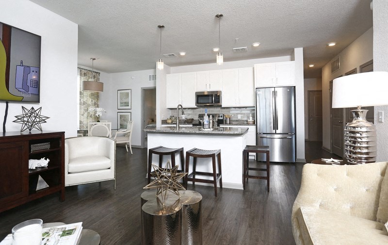 a kitchen and living room with a table and chairs