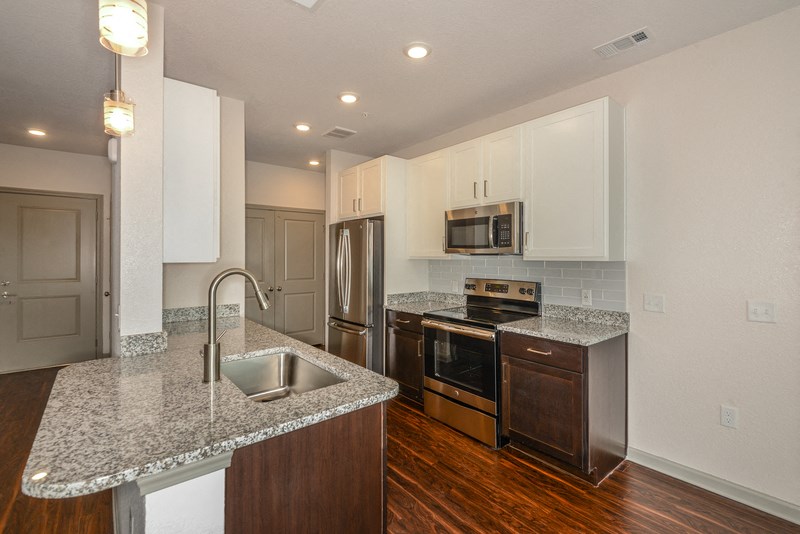 a kitchen with granite counter tops and stainless steel appliances