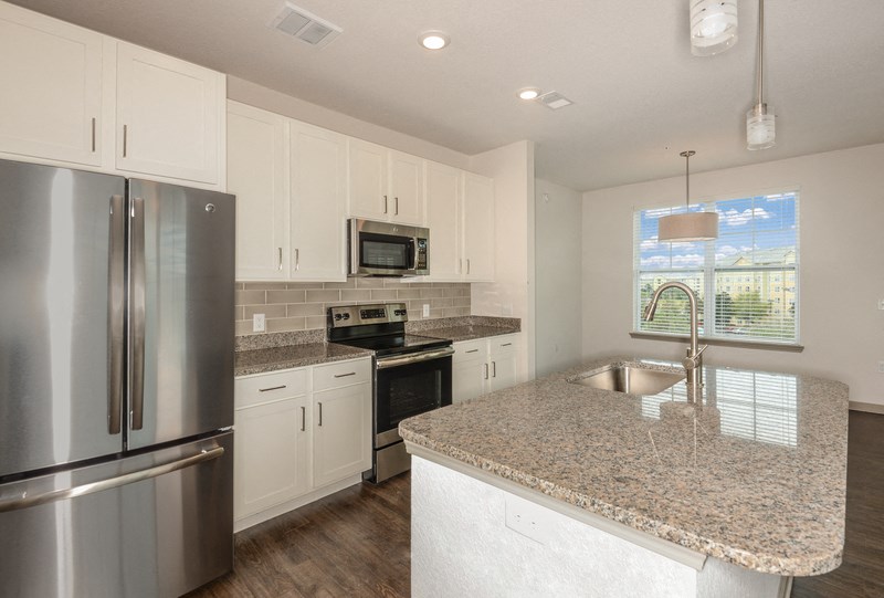 a kitchen with granite counter tops and stainless steel appliances