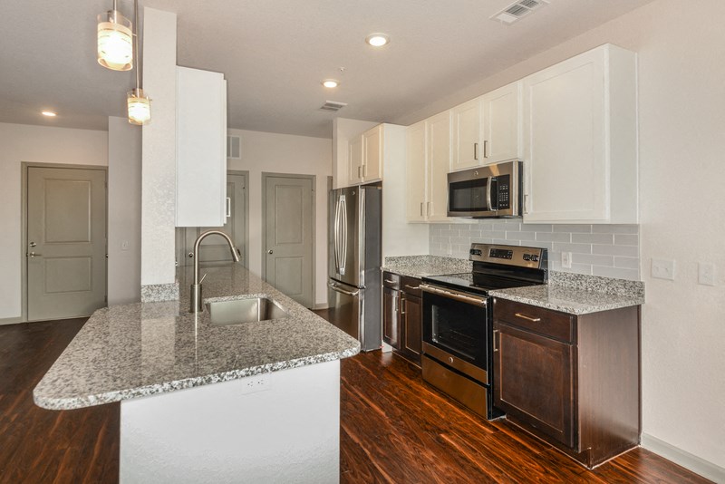 a kitchen with granite counter tops and stainless steel appliances