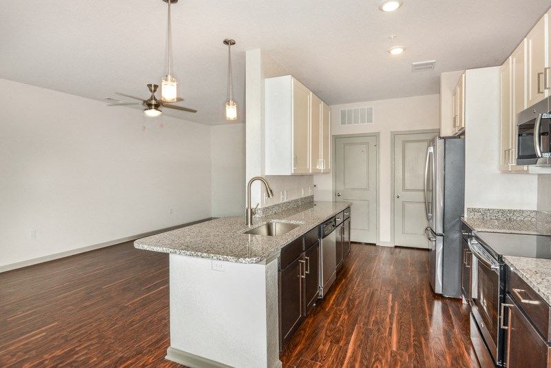 a kitchen with granite counter tops and stainless steel appliances