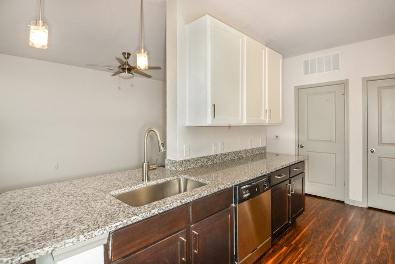 a kitchen with a granite counter top and a sink