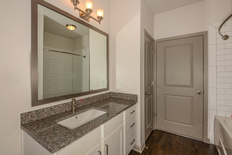 an empty bathroom with a sink and a mirror