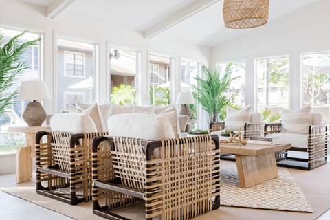 A living room with white furniture and a large window.