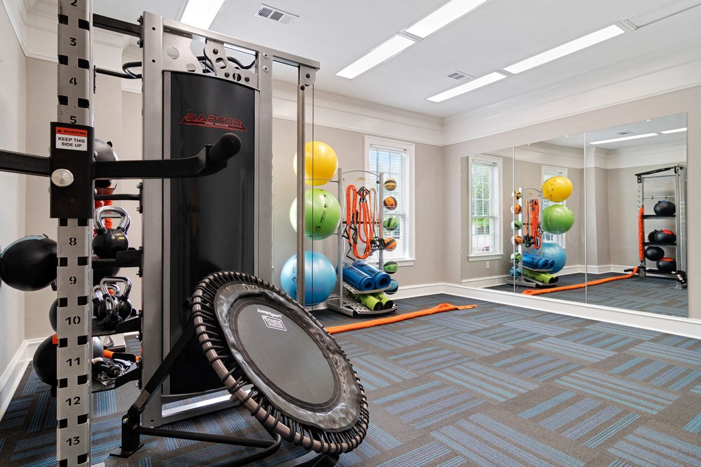 Fitness center with strength and conditioning equipment and large windows for natural lighting