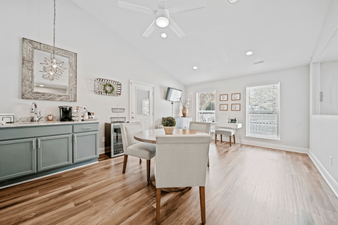 A modern kitchen with a dining table and chairs.