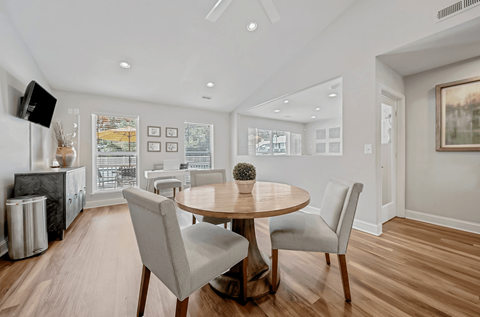 A modern dining room with a round table and chairs.