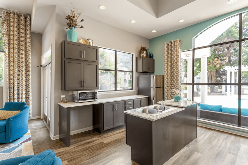 a kitchen with gray cabinets and a large window at Bridges at Mallard Creek Apartment Homes, Charlotte, NC