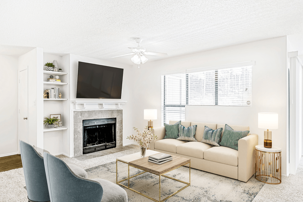 a living room with a fireplace and a tv  at Bridges at Mallard Creek Apartment Homes, Charlotte