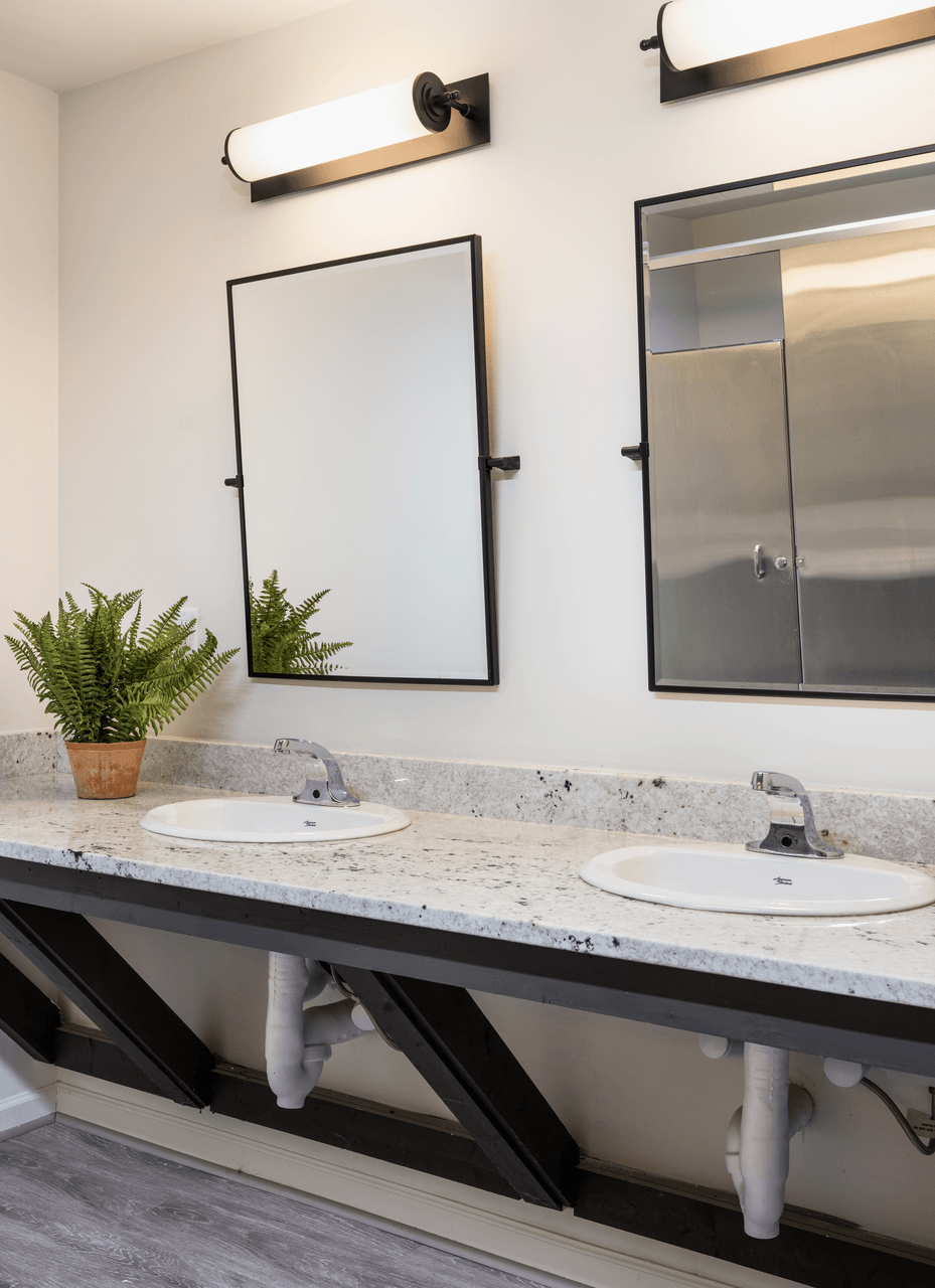 A Bathroom with two sinks and two mirrors at Bridges at Mallard Creek Apartment Homes, Charlotte, NC