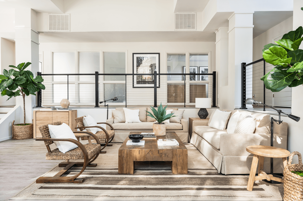 a living room filled with furniture and a large window at Bridges at Mallard Creek Apartment Homes, Charlotte