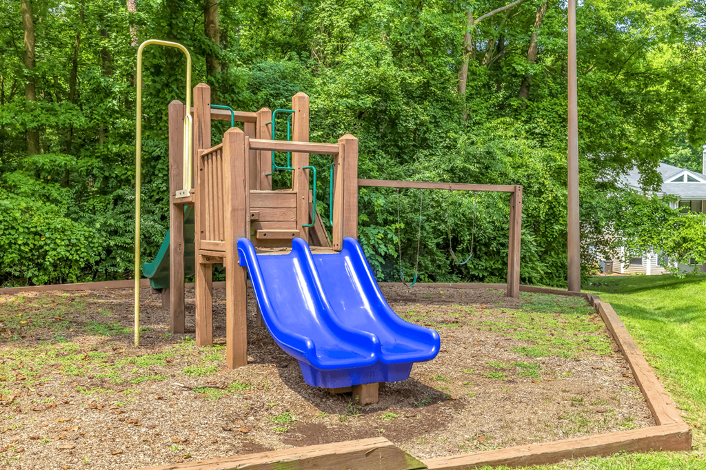 a playground with two slides at Bridges at Mallard Creek Apartment Homes, North Carolina, 28269