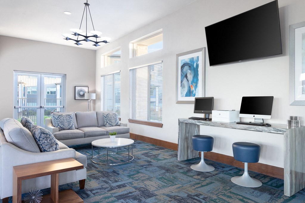 business center with computers, a television, and sofas