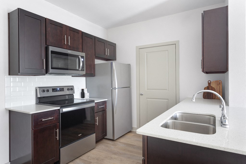 a kitchen with a sink and a stove