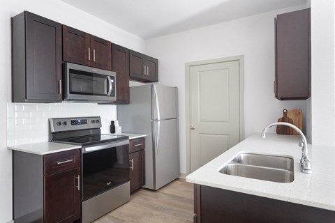 a kitchen with stainless steel appliances and wooden cabinets