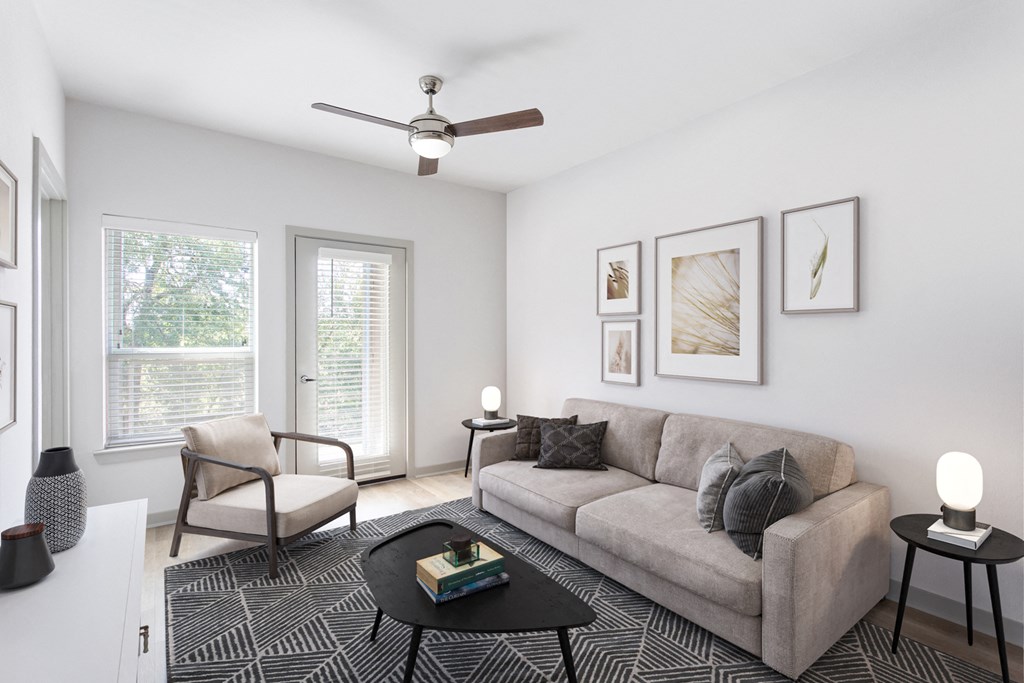 an image of a living room with a couch and windows