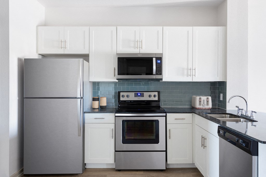 kitchen with stainless steel appliances and white cabinets