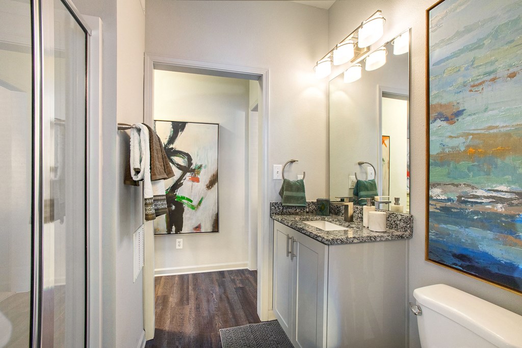 a bathroom with a shower and a sink and a mirror