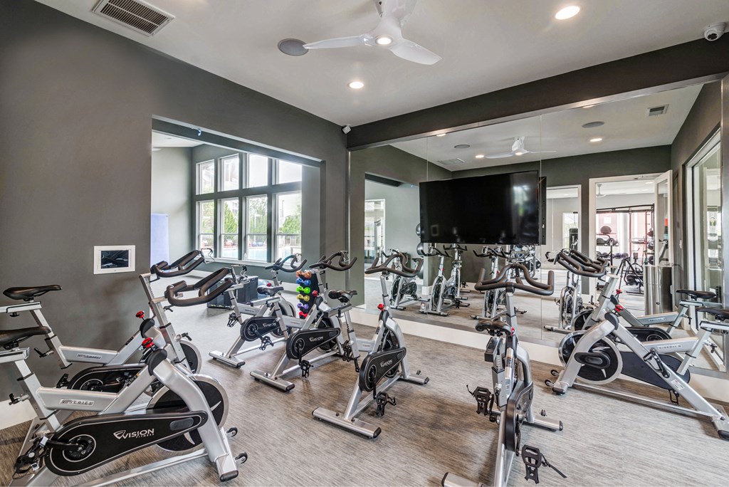 a row of exercise bikes in the gym