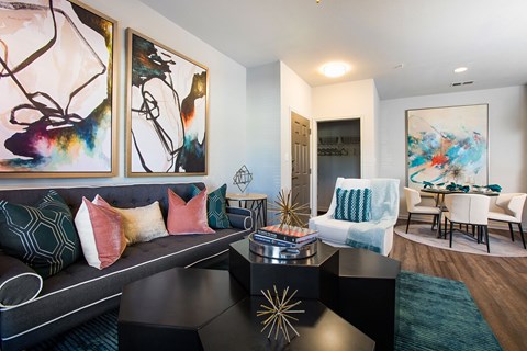 A living room with a grey couch and a coffee table with a gold star decoration.