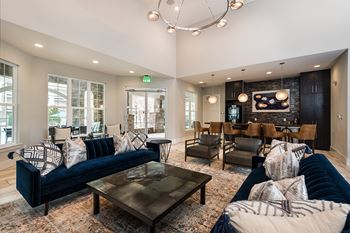 a large living room with couches and chairs and a dining room table