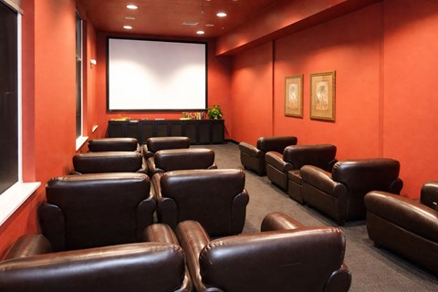 leather chairs in a media room with a screen in front of them