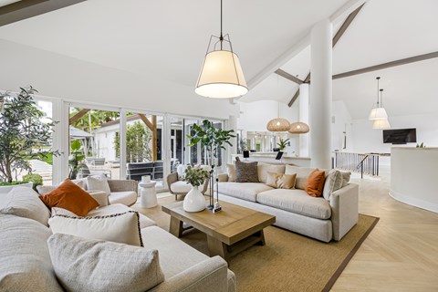 A living room with a white couch and a coffee table.