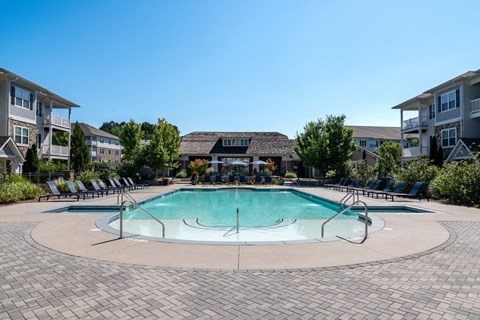 Swimming pool with large sundeck and lounge chairs
