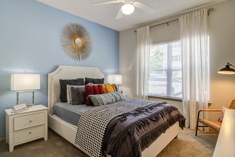 a bedroom with a bed and a ceiling fan